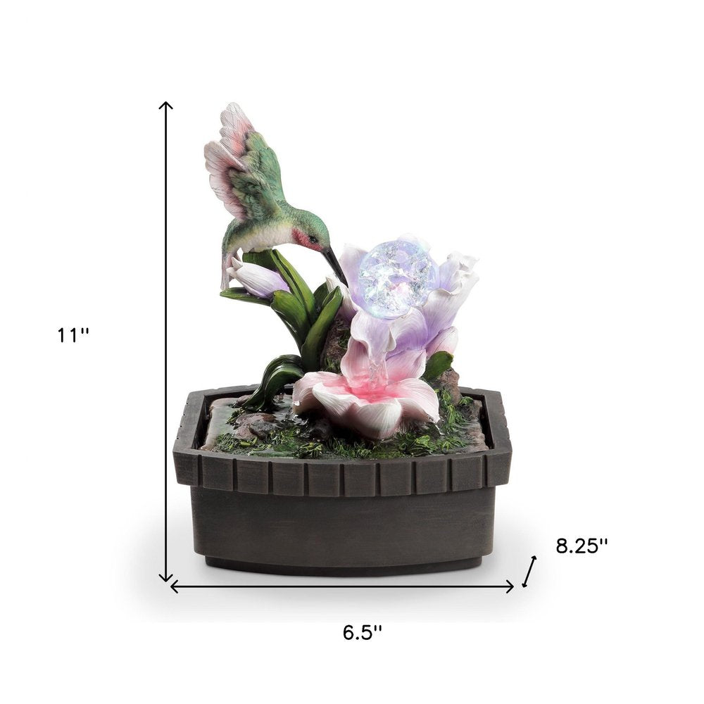 11" Pink Green And Brown Polyresin Hummingbird Tabletop Fountain. Home product isolated on a plain white background, showing a resin surface.