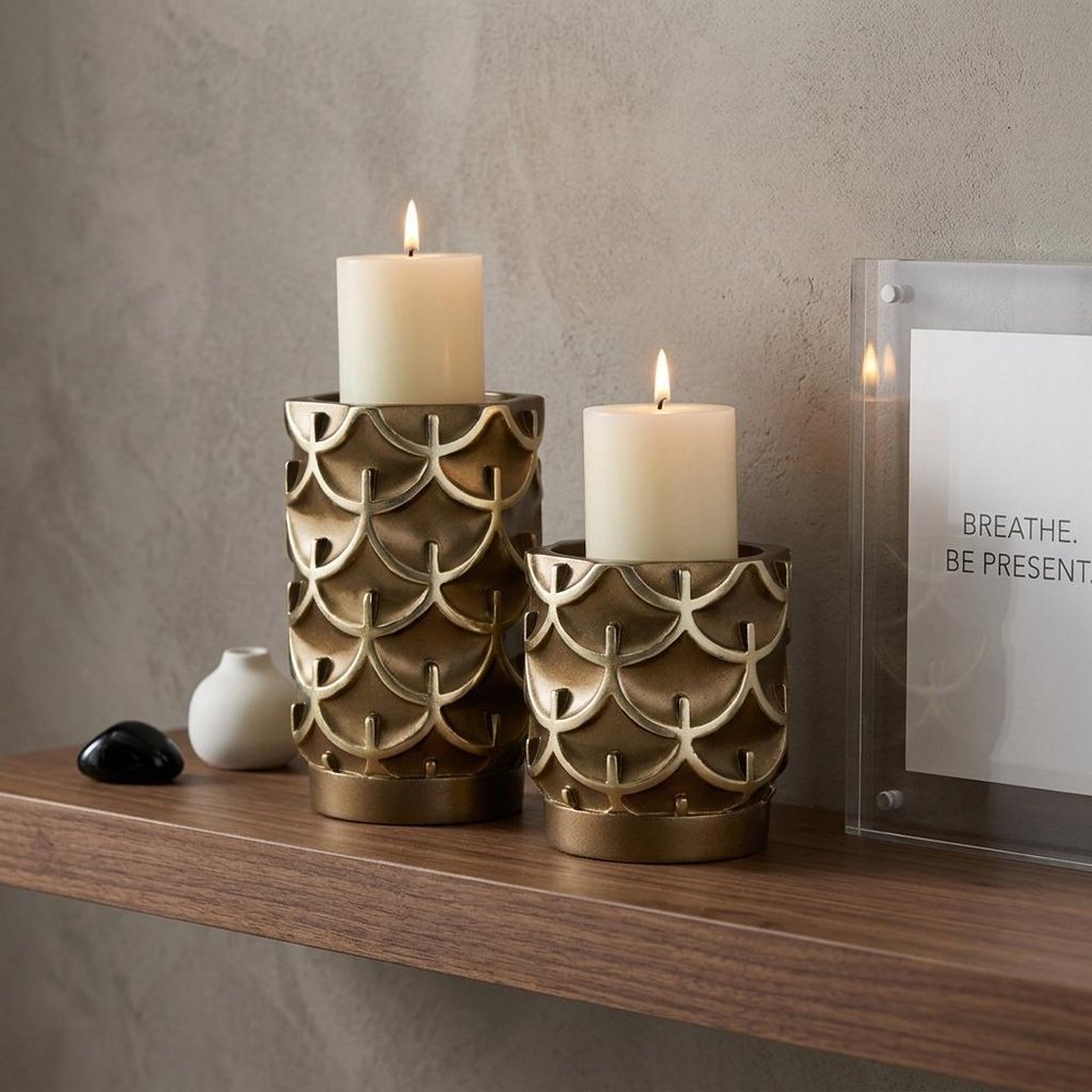 Set Of Two Antiqued Brass Tabletop Pillar Candle Holders in a home interior