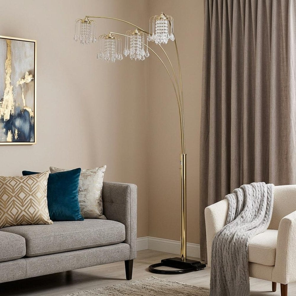 84" Gold Four Light Tree Floor Lamp With Clear Glass Novelty Shade in a home interior