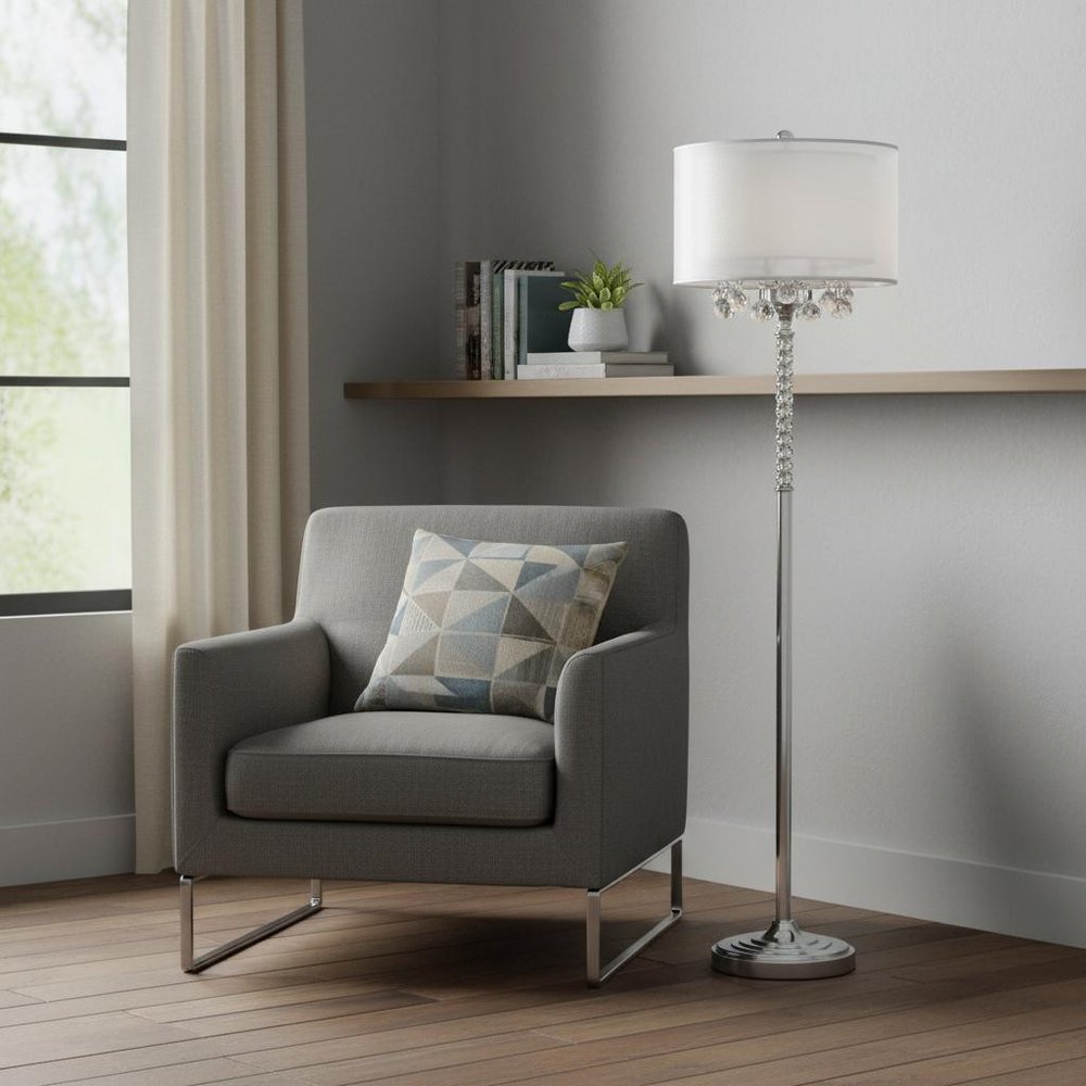 63" Silver Three Light Candelabra Floor Lamp With White Fabric Drum Shade standing in a furnished interior on a wood floor.