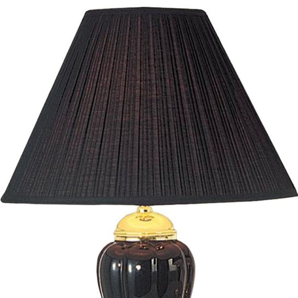 27" Black and Gold Ceramic Urn Table Lamp With Black Empire Shade. Table lamp isolated on a plain white background, showing a black ceramic surface.