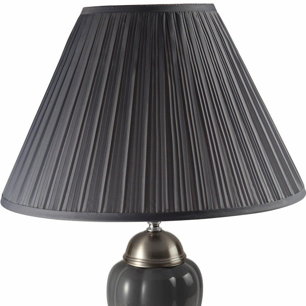 27" Gray and Silver Metal Urn Table Lamp With Gray Empire Shade. Table lamp isolated on a plain white background, in a silver metal finish.