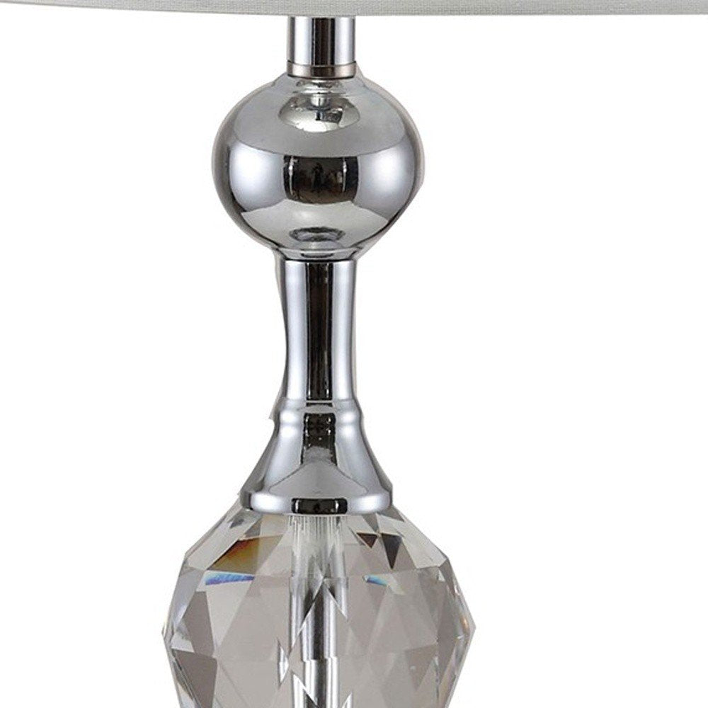 30" Silver Metal Bedside Table Lamp With White Classic Drum Shade. Table lamp isolated on a plain white background, finished in silver metal.