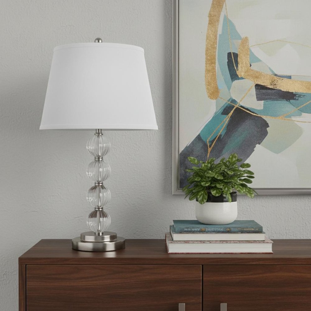 29" Silver Metal Table Lamp With White Classic Empire Shade displayed on a dark wood tabletop in a furnished interior against a light gray wall.