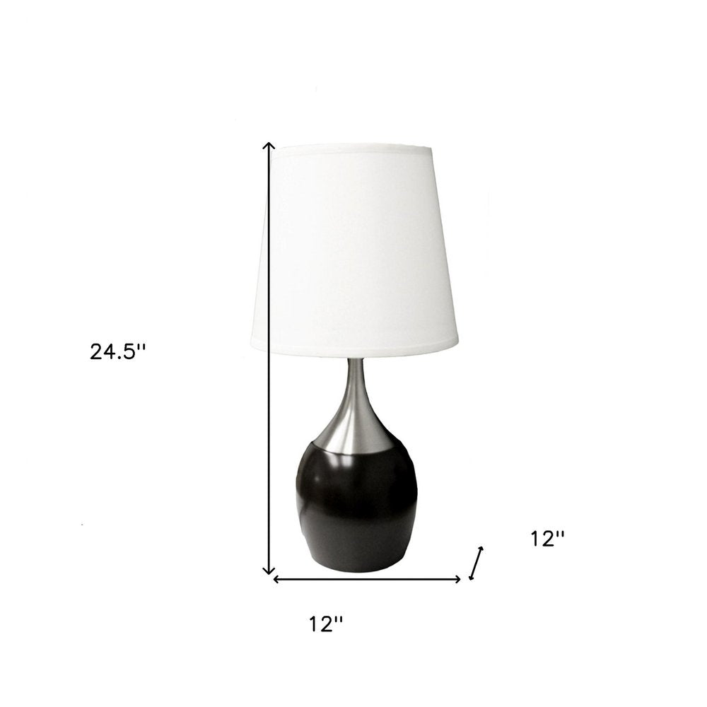 25" Black and Silver Gourd Table Lamp With White Tapered Drum Shade. Table lamp isolated on a plain white background, in a silver finish.