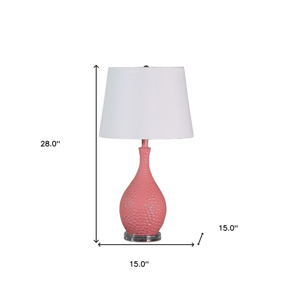 28" Pink Hammered Urn Table Lamp With White Tapered Drum Shade. Table lamp isolated on a plain white background, finished in white.