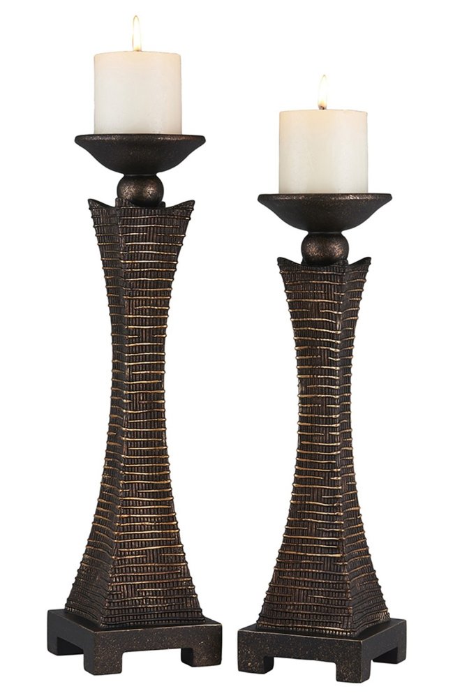 Two bronze polyresin woven tabletop pillar candle holders with white pillar candles on a white background.