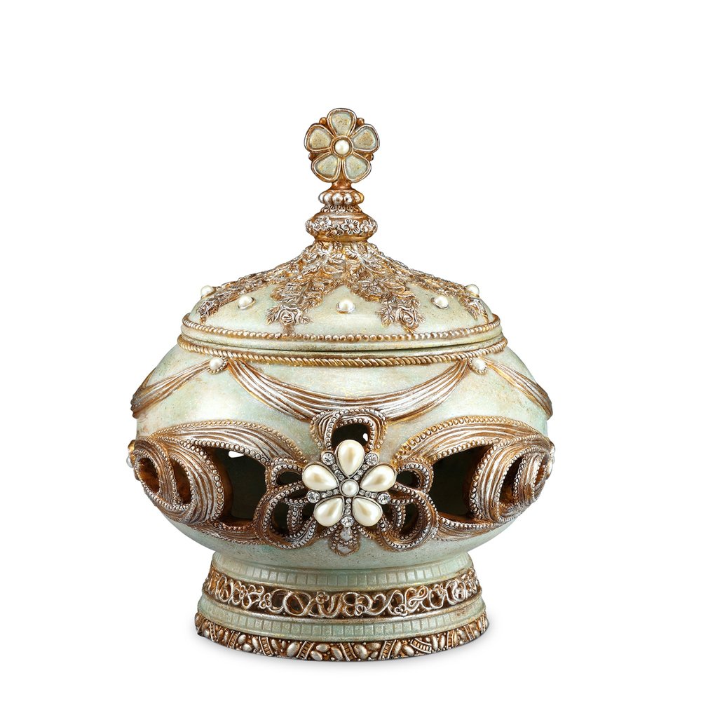 A light green and bronze gold resin jewelry box with floral and scroll details, pearls, and crystals on a white background.