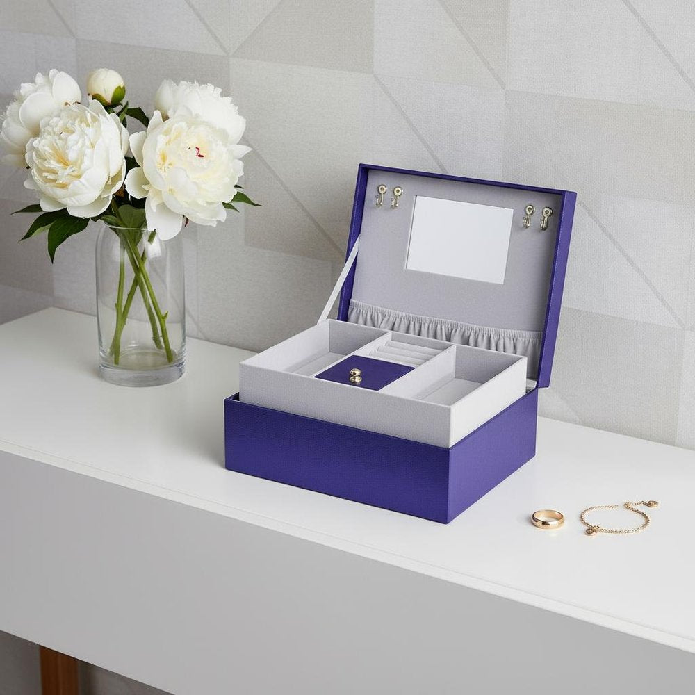 10" Azure Faux Leather Six Section Mirrored Jewelry Box styled in a furnished interior with a light gray wall on a tiled floor in light gray faux leather.