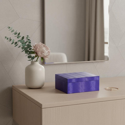 10" Azure Faux Leather Six Section Mirrored Jewelry Box styled in a furnished interior with a tan wall on a wood floor in tan faux leather.