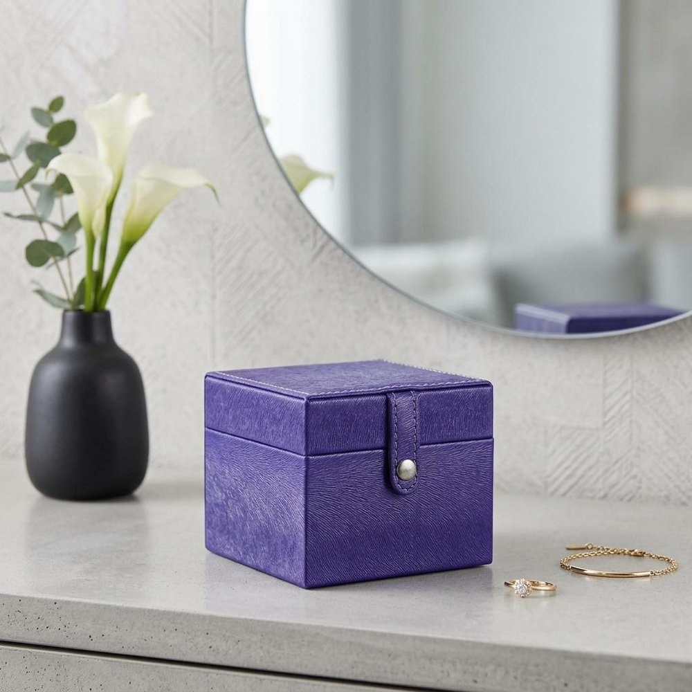 4" Azure Faux Leather Five Section Jewelry Box Travel Case With Mirror styled in a furnished interior with an off-white wall on a tiled floor in light gray faux leather.