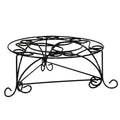 Black metal plant stand with decorative scrollwork on a white background.