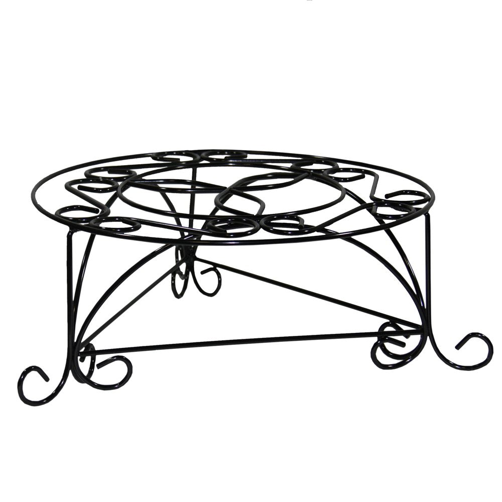 Black metal plant stand with decorative scrollwork on a white background.