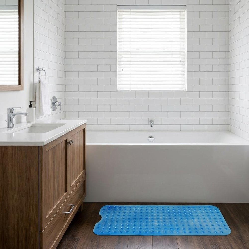 40" Translucent Blue Bubbles Non Slip Bathtub Mat styled in a furnished interior with a light gray wall on a dark wood floor.