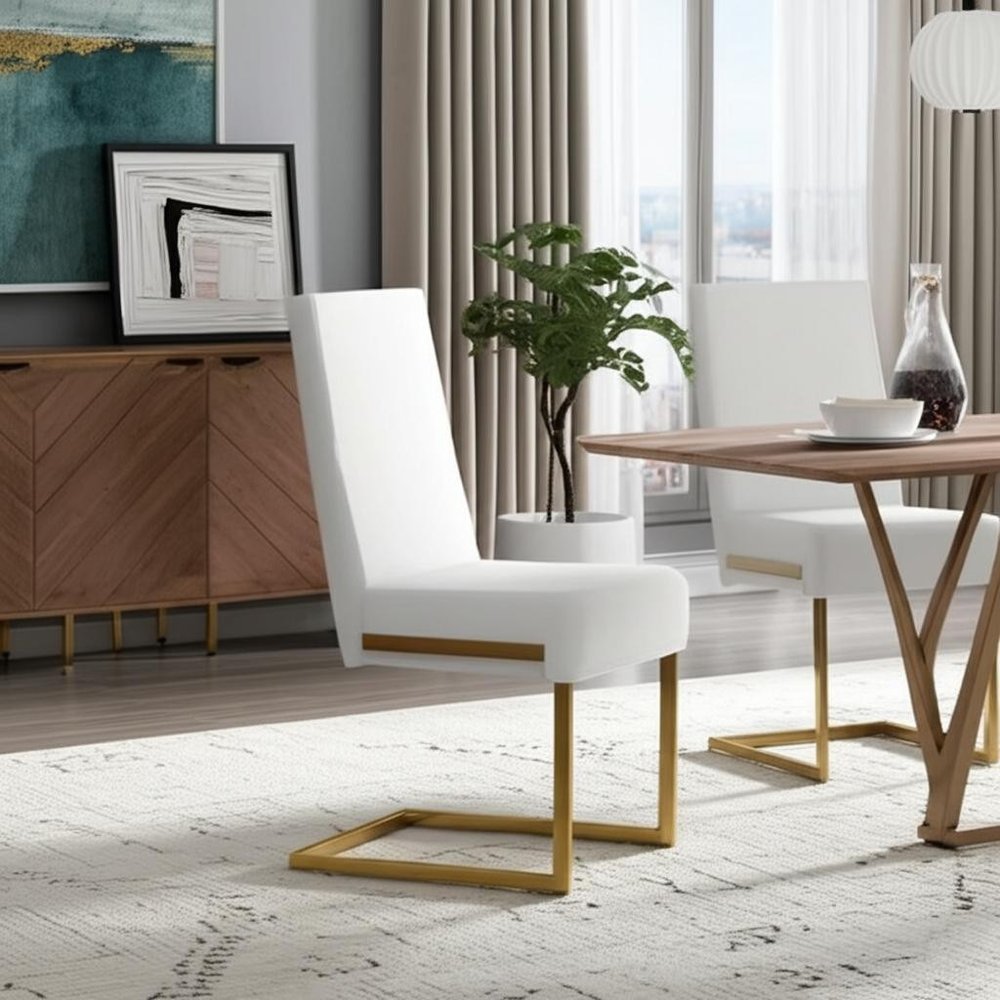 Set of Two White and Gold Upholstered Faux Leather Dining Side Chairs in a home interior