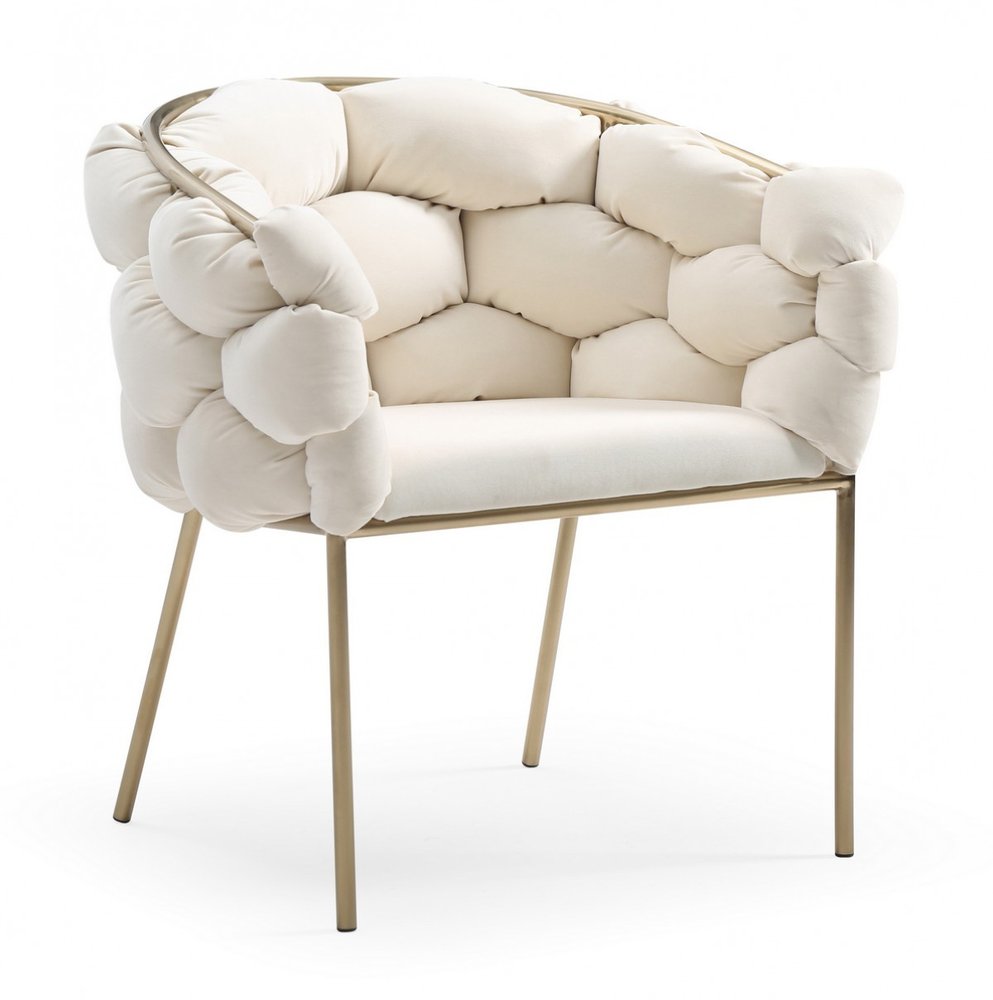 White upholstered fabric dining arm chair with brass frame and legs on a white background.