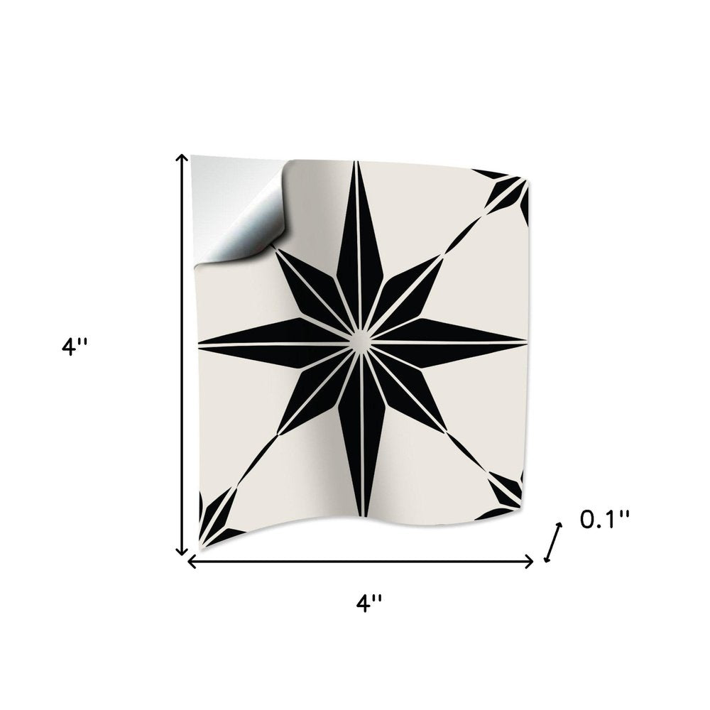4" x 4" black and white mono cross peel and stick tile with a starburst design on a white background.