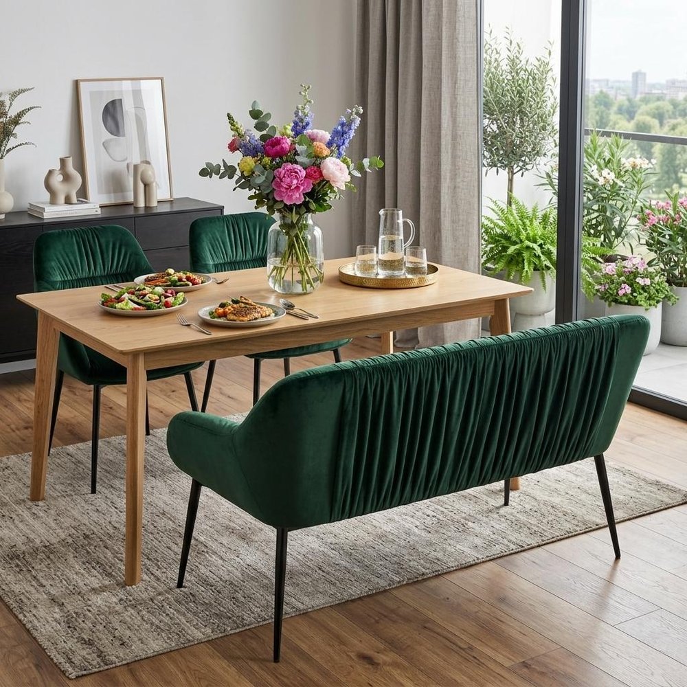 56" Green and Black Velvet Upholstered Dining Bench shown outdoors on an outdoor setting with greenery.