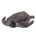 A grey, textured sea turtle statue with detailed shell and flippers, shown from a slightly elevated front view on a white background.