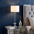 26" Silver Metal And Faux Crystal Table Lamp With White Cylinder Shade shown outdoors on an outdoor setting.