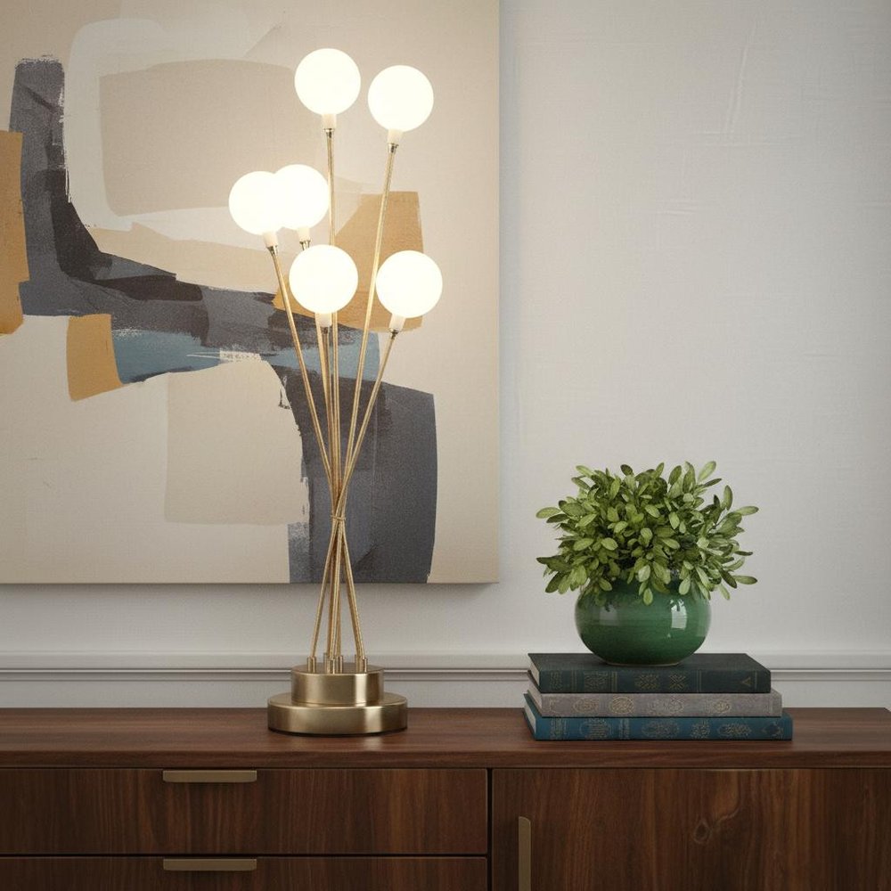 28" Yellow Gold Six Light Globe Desk or Table Lamp displayed on a dark wood tabletop in a furnished interior against a light gray wall.
