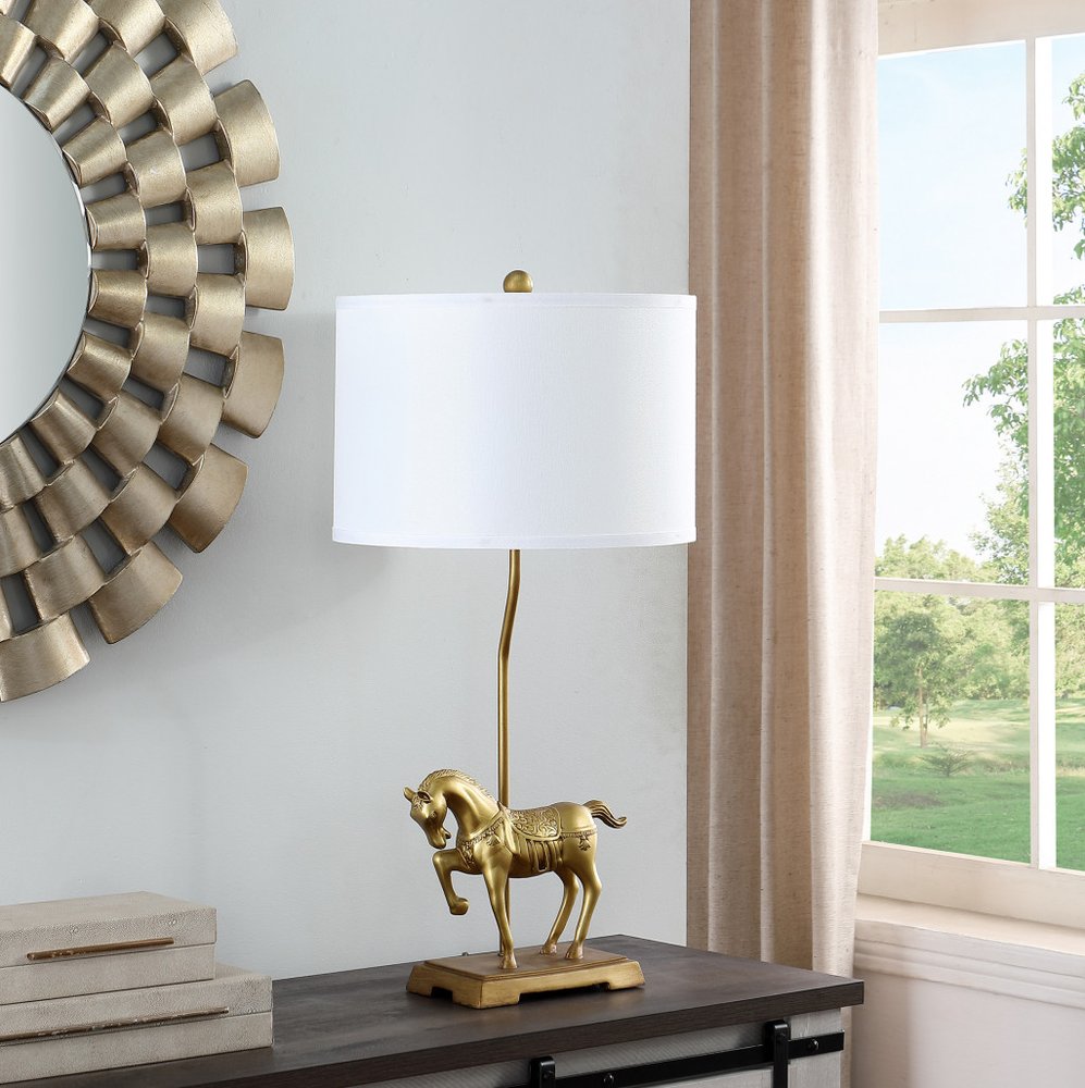 30" Gold Stallion Horse Table Lamp With White Shade displayed on a tabletop in a furnished interior against an off-white wall.