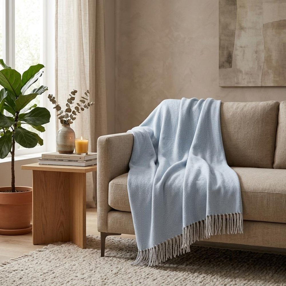 Sky Blue Mini Dot Fringed Throw Blanket in a home interior