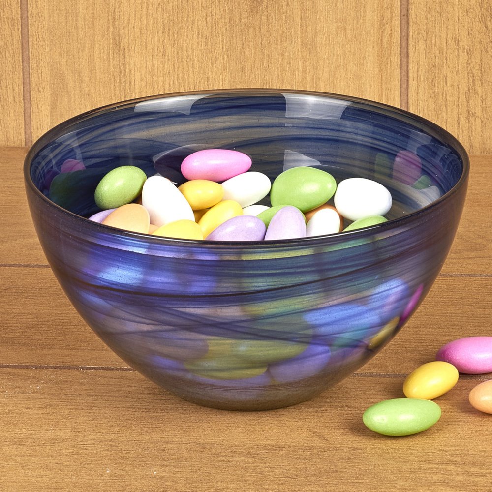 Cobalt and white alabaster glass round candy or nut bowl filled with pastel-colored candies on a wooden surface.
