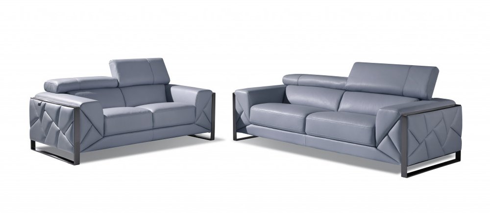 Two light blue Italian leather sofas with geometric patterned arms on a white background.