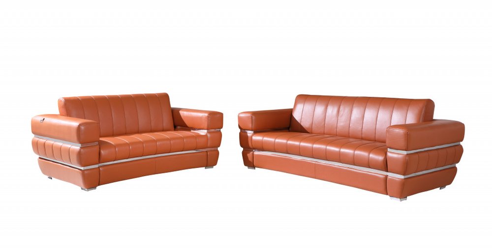 Two camel Italian leather sofas with chrome accents on a white background.