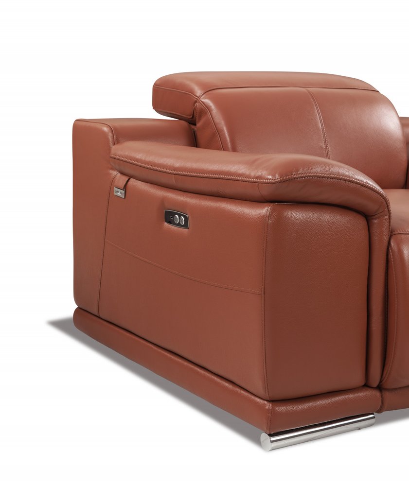 Close-up of a camel-colored Italian leather sofa armrest with a control panel and chrome legs on a white background.