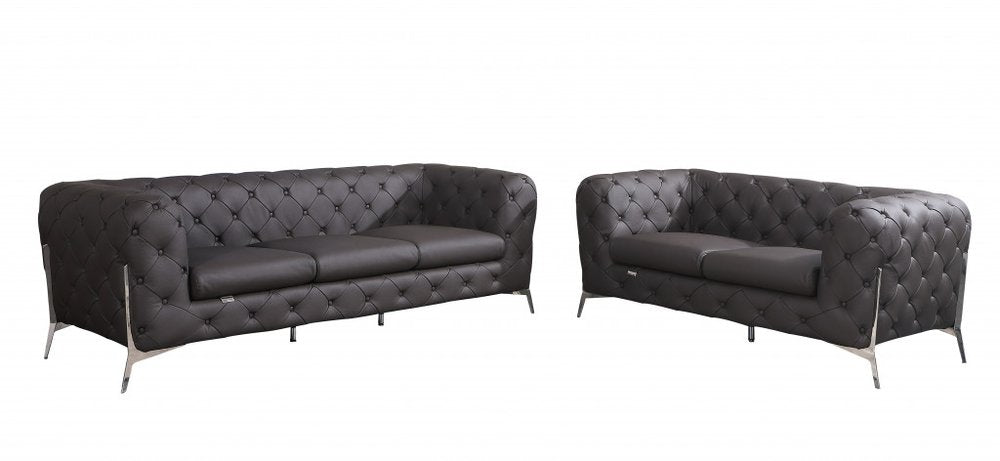 Two brown Italian leather chesterfield sofas with silver legs on a white background.