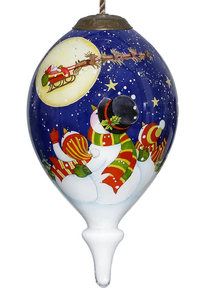 Hand-painted glass Christmas ornament depicting a snowman family watching Santa's sleigh in a starry night sky.