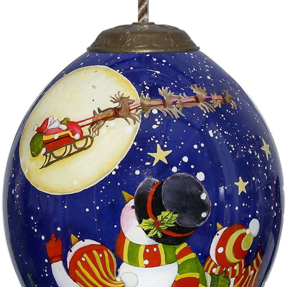 Snowmen Family Watching Santa on a Sleigh Hand Painted Mouth Blown Glass Ornament on a white background