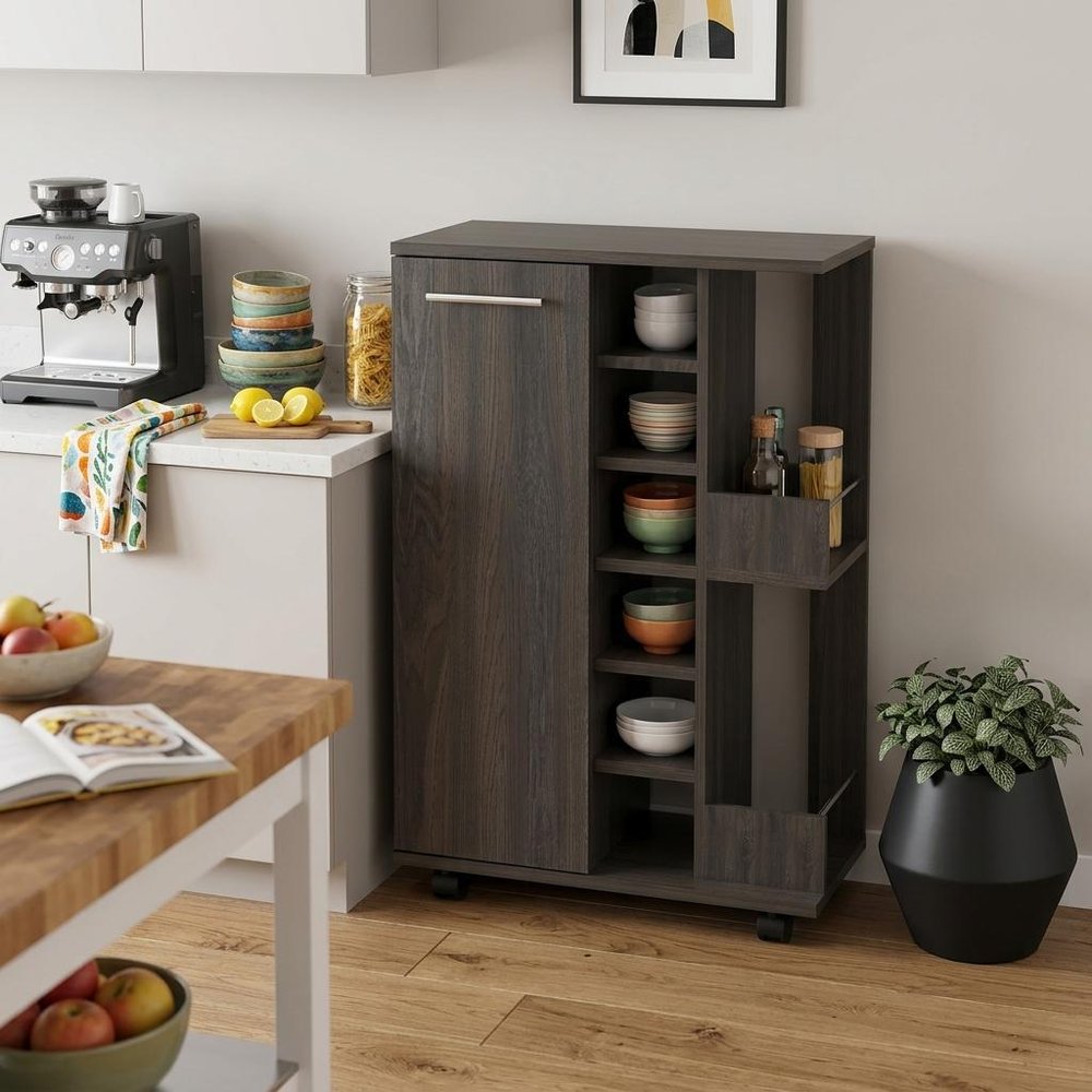 24" Espresso Wood Flat Door Rolling Kitchen Cart With Storage styled in a furnished interior with a light gray wall on a wood floor in tan wood.