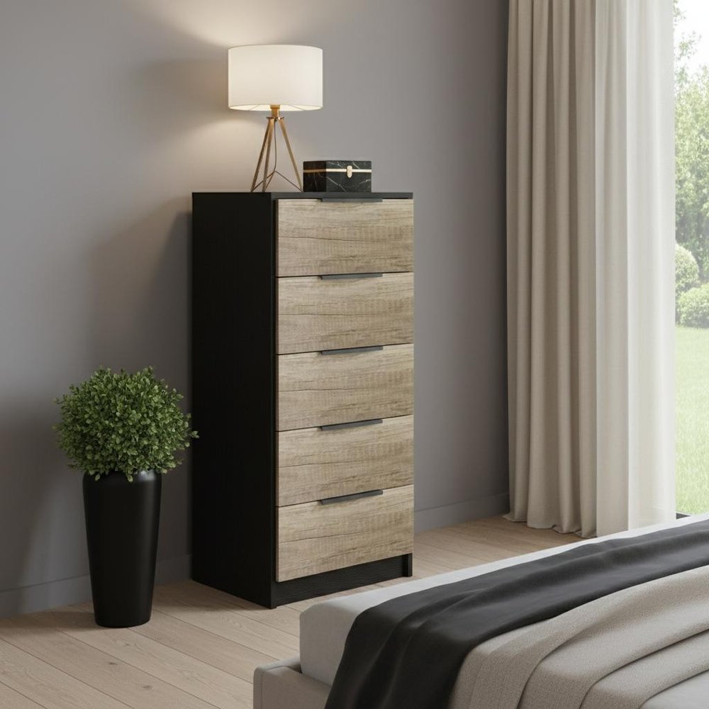 18" Black And Brown Wood Five Drawer Dresser styled in a furnished interior with a gray wall on a wood floor.