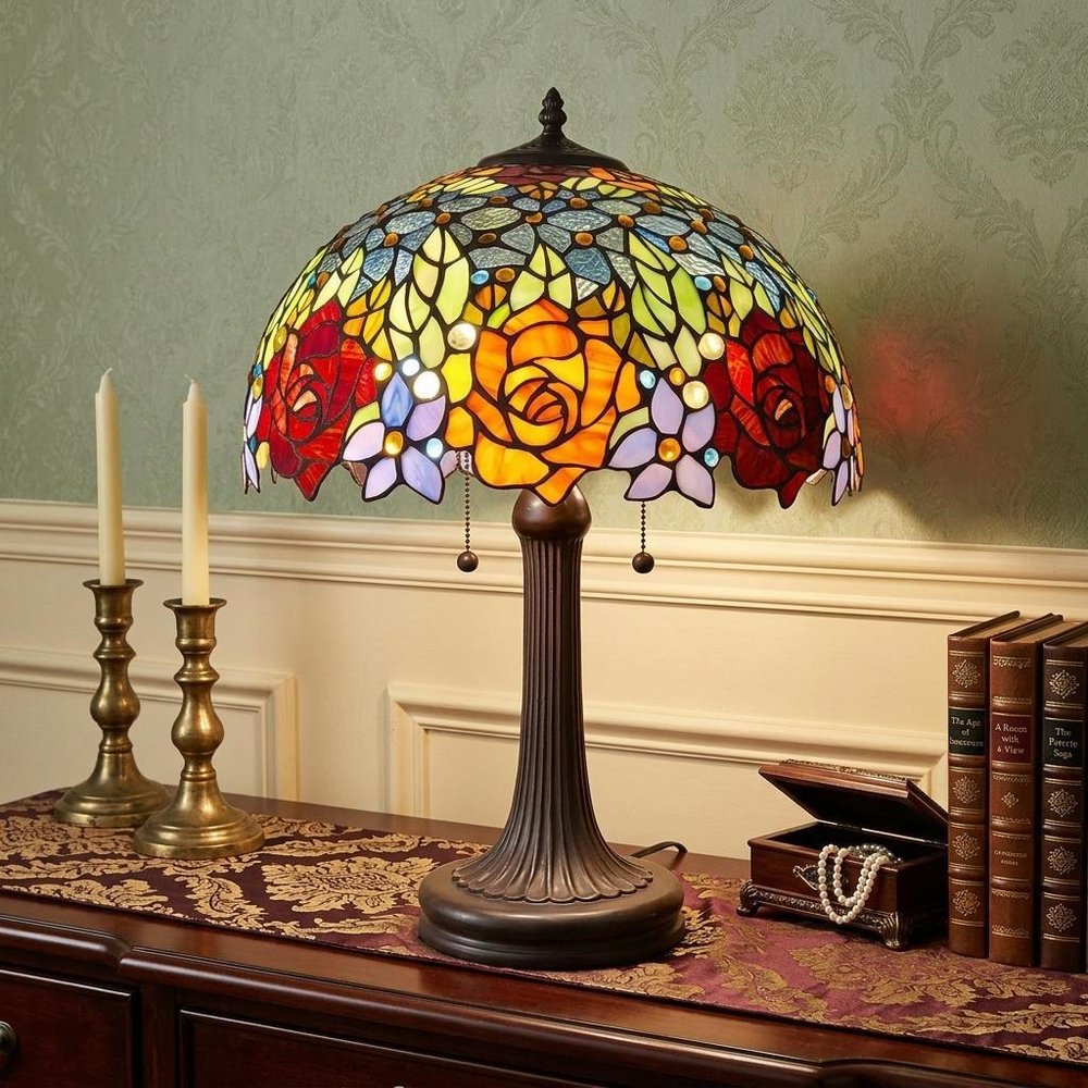 24" Dark Brown Metal Two Light Candlestick Table Lamp With Orange Shade displayed on a tabletop in a furnished interior against a gold wall.