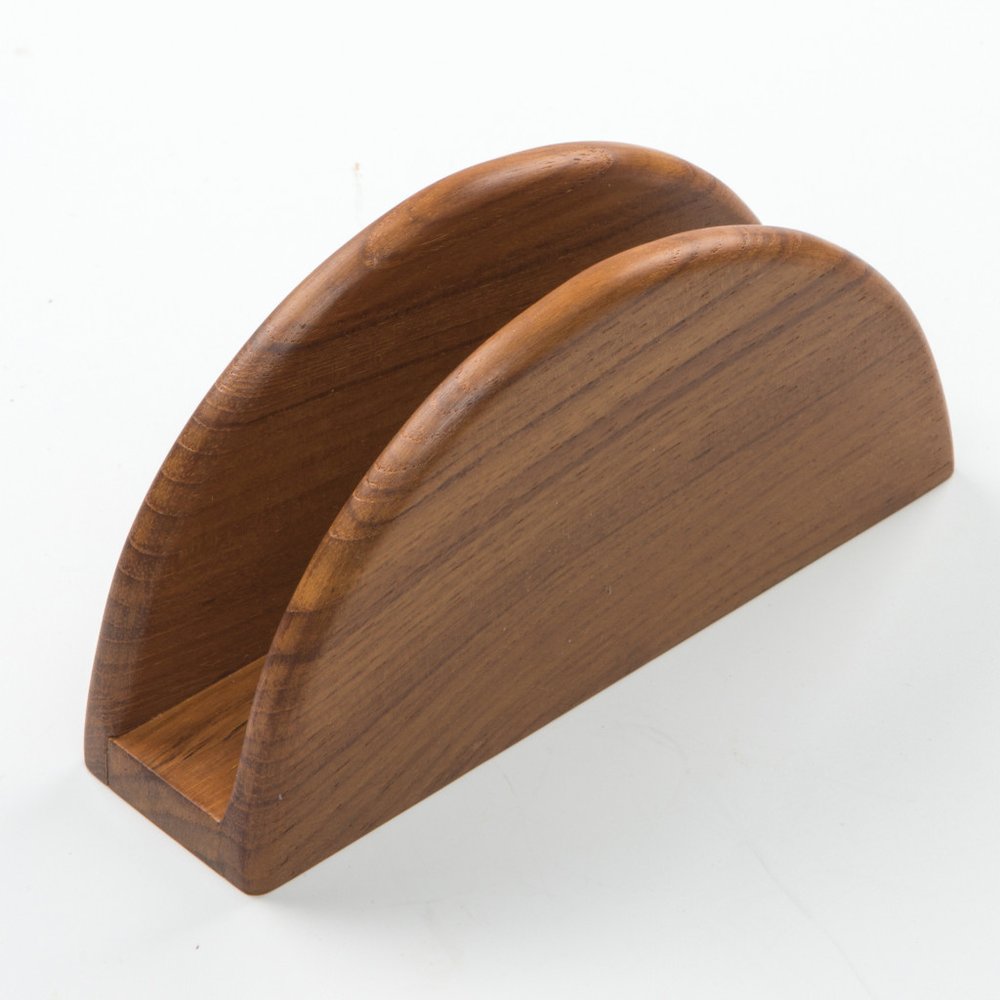 A brown solid wood napkin holder with a curved design on a white background.