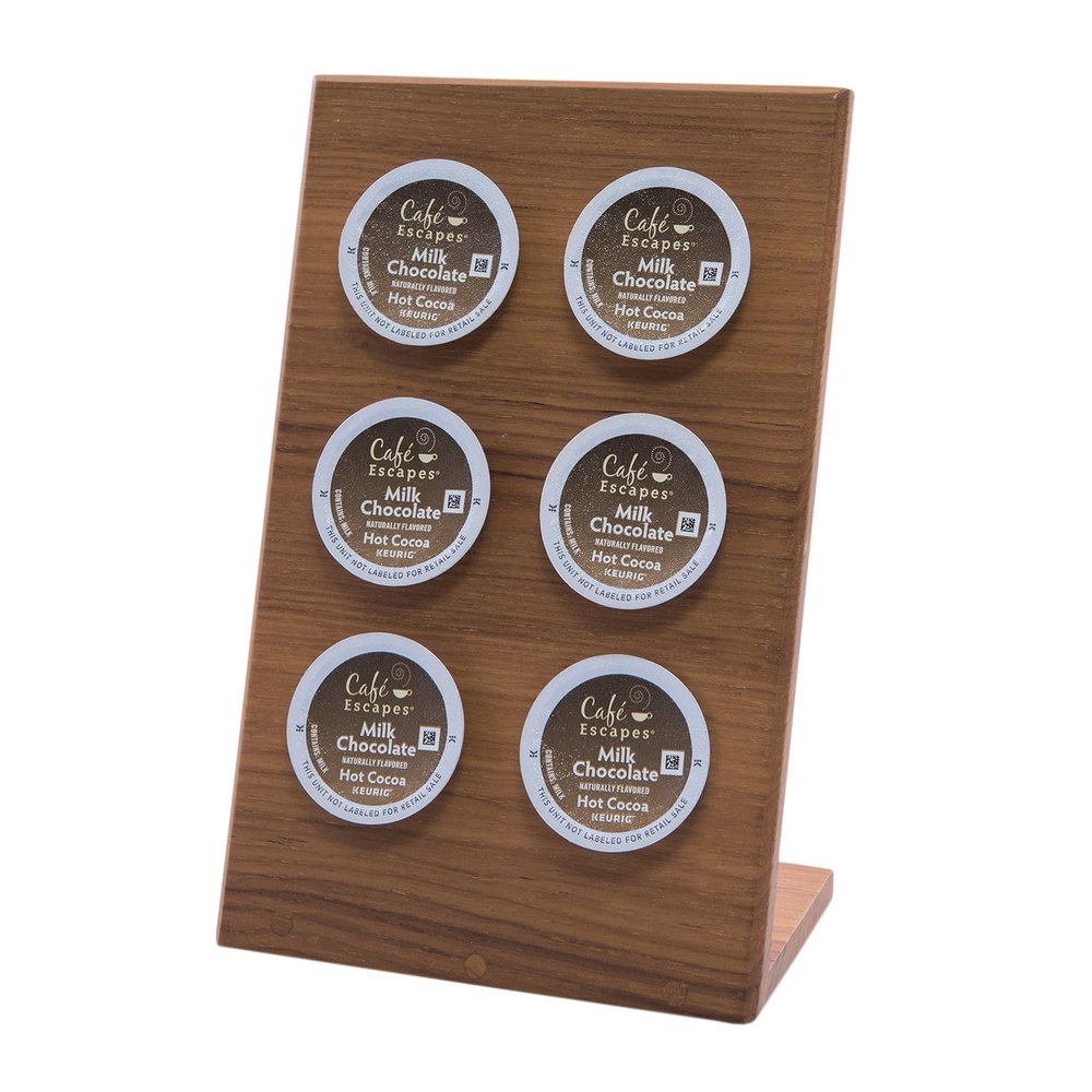 Wooden coffee pod holder with six Cafe Escapes Milk Chocolate Hot Cocoa pods on a white background.