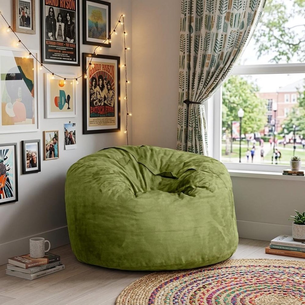 47" Green Microsuede Classic Bean Bag styled in a furnished interior with a tan wall on a wood floor.