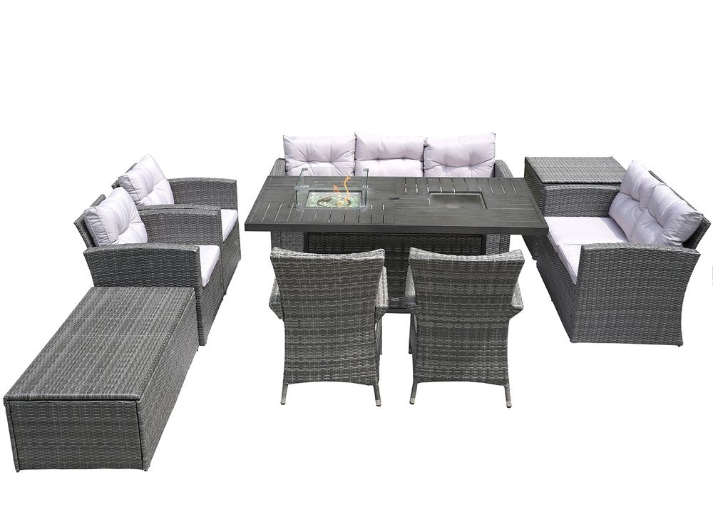 Gray wicker outdoor seating group with multiple chairs, a fire pit table, and a chaise lounge on a white background.