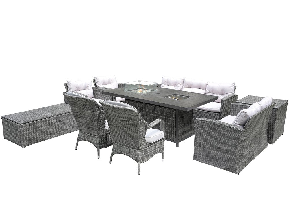 Gray wicker outdoor seating group with fire pit table, multiple chairs, sofa, and storage bench on white background.