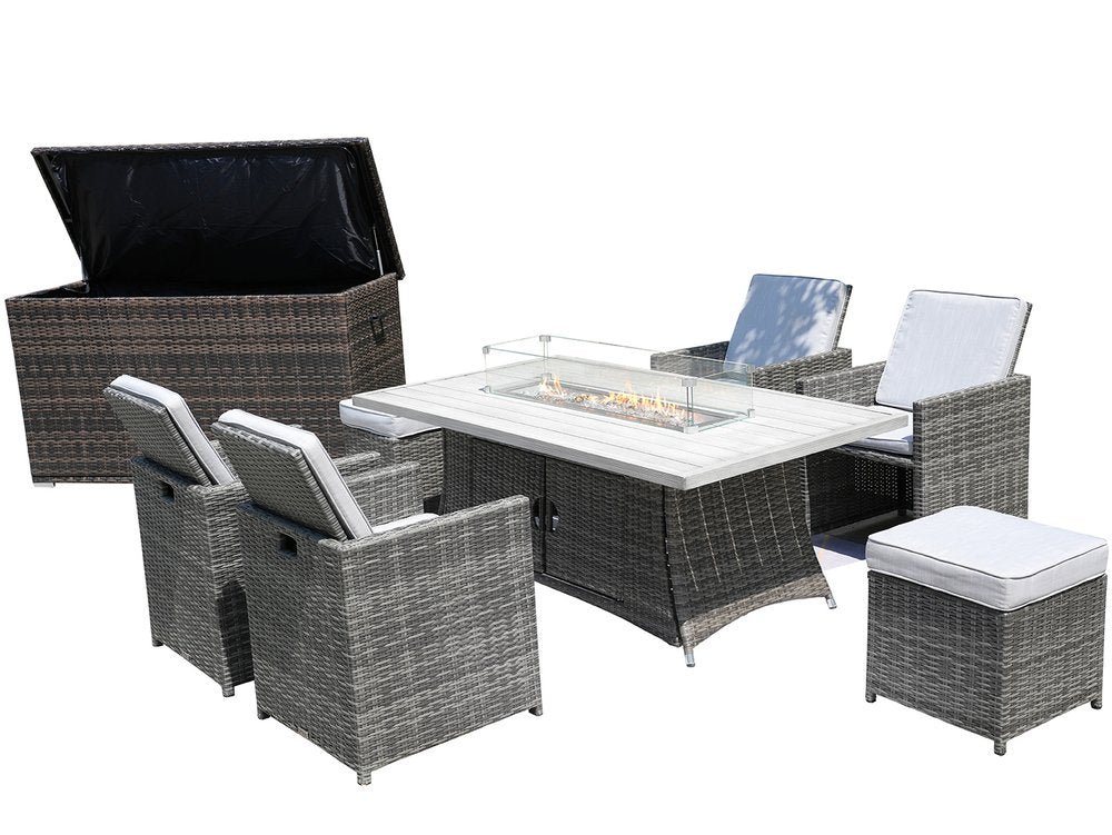 Gray wicker outdoor seating group with fire pit table, four chairs, and storage box on white background.