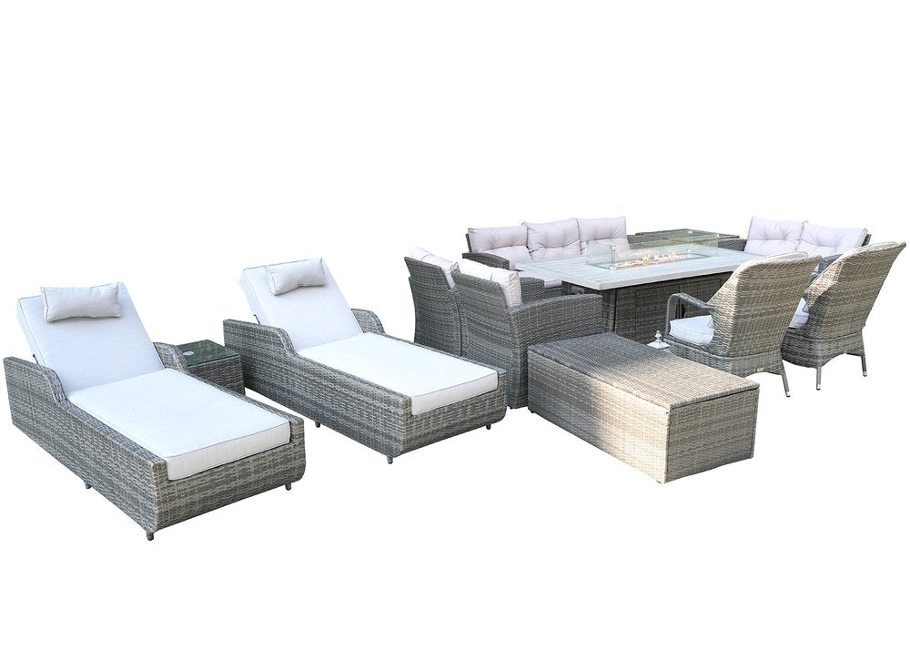 Gray wicker outdoor seating group with multiple chairs, chaise lounges, a fire pit table, and a storage ottoman on a white background.