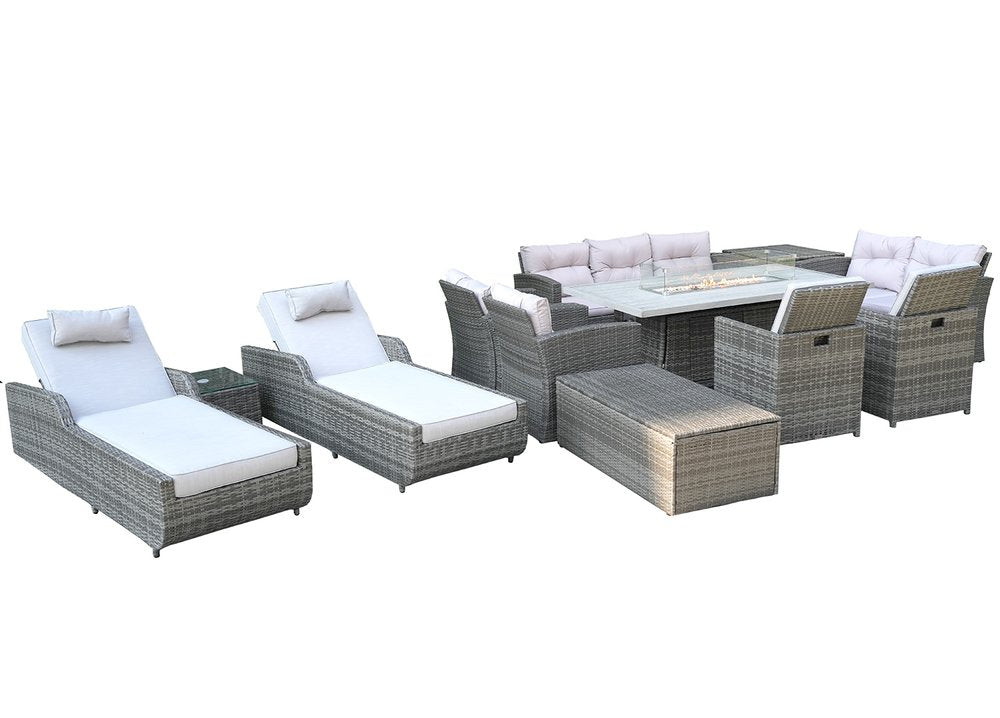 Gray wicker outdoor seating group with multiple chairs, chaise lounges, a fire pit table, and storage ottomans on a white background.