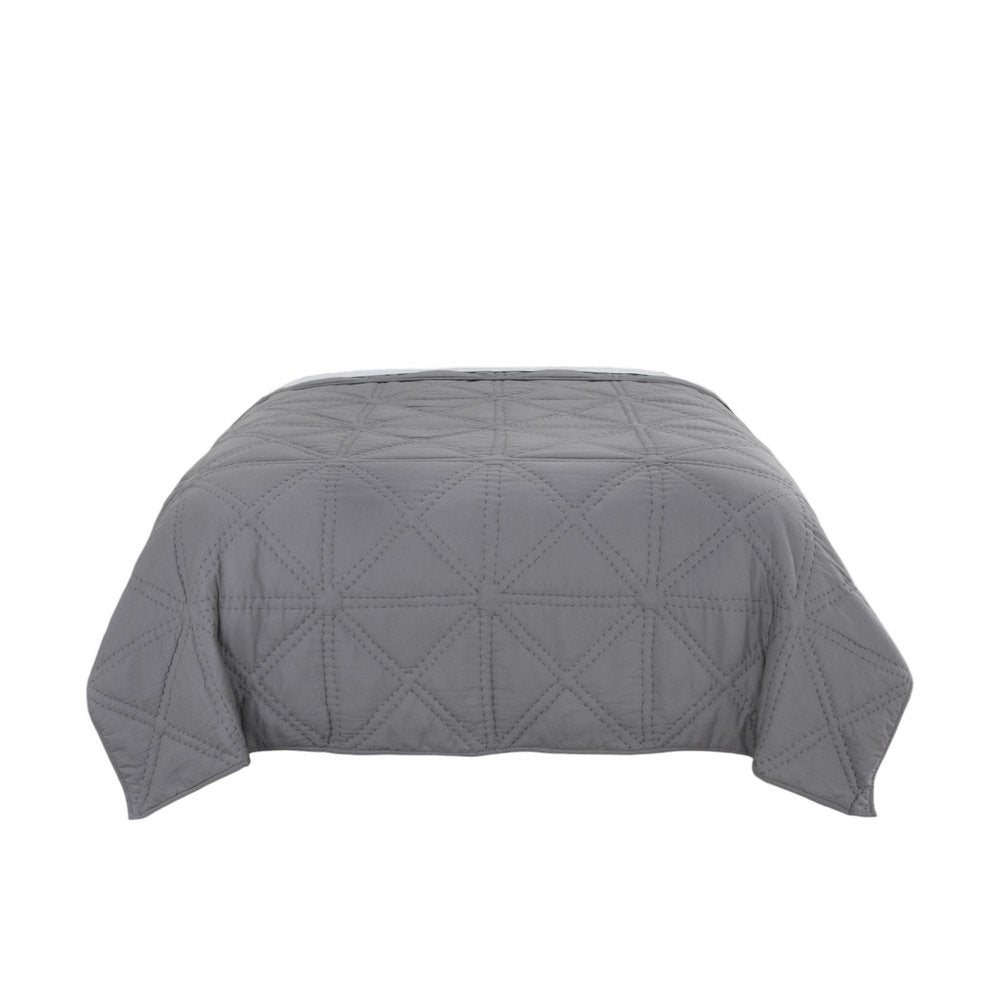 Gray geometric king quilt on a white background.
