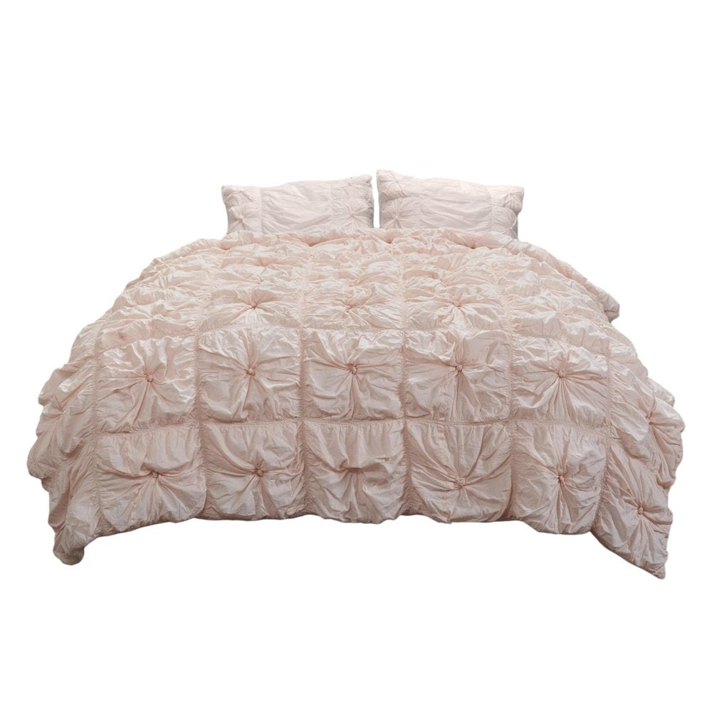Pink twin comforter set with two shams, featuring a textured, ruched design on a white background.