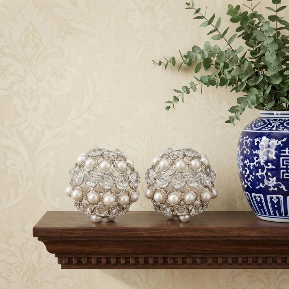 Set of Two Silver and Clear Faux Crystal and Pearl Decorative Orbs in a home interior