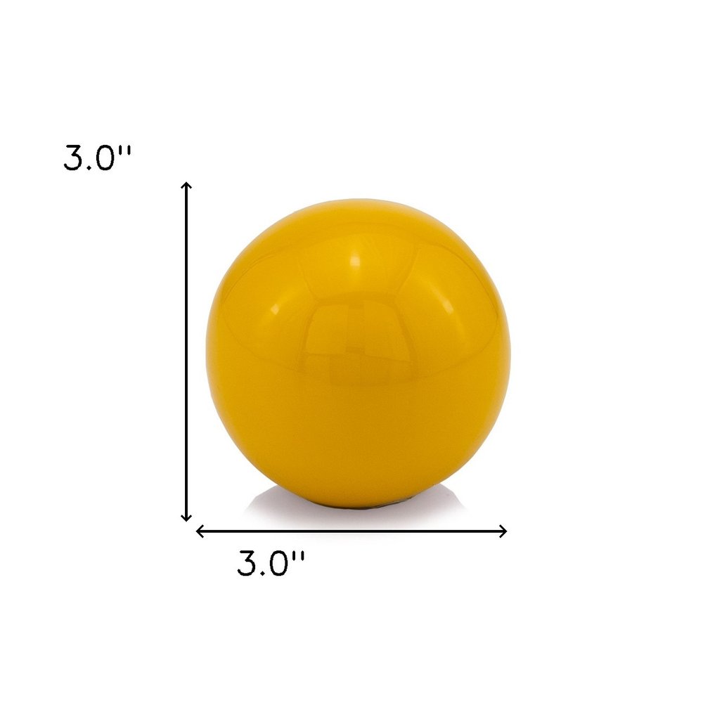 3" Yellow Aluminum Decorative Orb Tabletop Sculpture. Sculpture isolated on a plain white background, in a yellow metal finish.