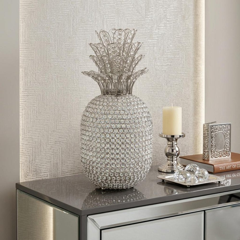 23" Glam Bling Faux Crystal and Silver Pineapple styled in a furnished interior with a light gray wall on a tiled floor.